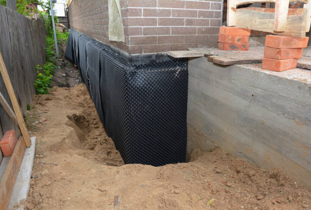 SJ Waterproofing Pros technician performing targeted Wet Basement Repair assessment in Clay Center, OH